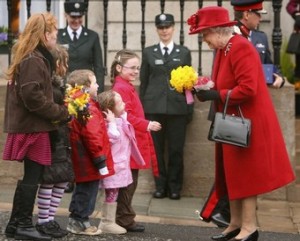 Britain's Queen Elizabeth II (R) receives flowers from children as she departs St Patrick's Cathedral in Armagh, Northern Ireland, March 20, 2008. The Queen handed out Maundy Thursday alms purses to 82 men and 82 women, the presentations are in recognition of their services to both church and community.