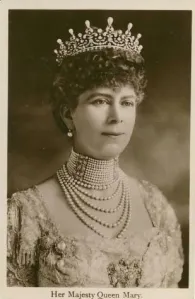 Shown in the photograph is Queen Mary (1867-1953), grandmother of Queen Elizabeth II. Queen Mary was a manic collector of jewelry and other fine pieces. During the reign of her husband, King George V (1865-1936), she vastly expanded the Royal Collection, often from the houses of friends. Mary is shown here wearing “the Girls of Great Britain and Ireland Tiara” which is also referred to as “Granny’s Tiara,” which she gave to Elizabeth in 1947, the year she married Prince Philip.