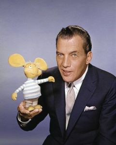 Ed Sullivan, host of “The Ed Sullivan Show,” CBS’ long-running (1948-1971), top-rated Sunday night variety show. Ed is shown with the little lovable Italian mouse puppet, Topo Gigio, that made more than fifty Sullivan appearances. On the show, Topo Gigio greeted Ed with a sugary "Hello Eddie!" and ended his weekly visits by crooning to the host, "Eddie, Keesa me goo'night!"