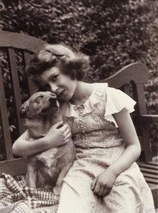 Princess Elizabeth, age 9 or 10, comforts her corgi Dookie, 1936