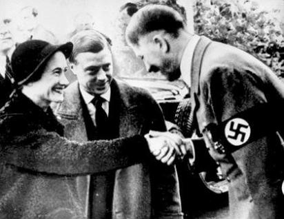 Adolf Hitler kisses the hand of the Duchess of Windsor as her husband the Duke looks on, admiringly. The Duke and Duchess of Windsor visited Germany in 1937 before WWII broke out across Europe. They were outspoken supporters of Nazi fascism and suspected of spying for Germany. At the beginning of the war, the Windsors were whisked out of France to safe haven in the Bahamas, where the Duke served out the war years as governor. There he could do Britain little harm - and he was less likely of being kidnapped by the Germans who were reportedly interested in installing him as a puppet king in a conquered Great Britain under German rule.