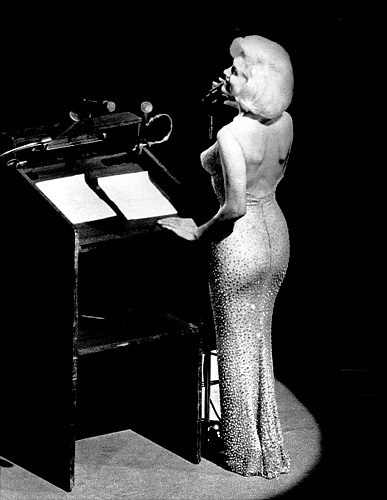 Marilyn Monroe at the microphone singing "Happy Birthday, Mr. President," at President John F. Kennedy's birthday bash, May 19, 1962. 