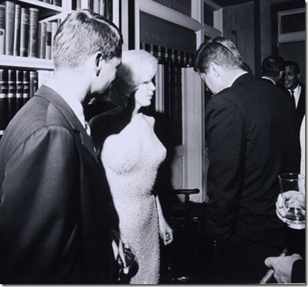 Bobby Kennedy, Marilyn Monroe, and President John Kennedy gather following Monroe's iconic performance of "Happy Birthday, Mr. President," at Madison Square Garden, May 19, 1962. Marilyn is still wearing the gown she wore in the performance which she referred to as "skin and beads."