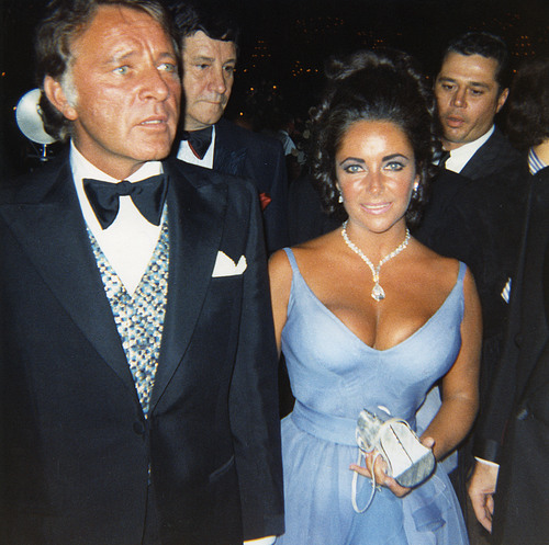 Richard Burton escorts wife Elizabeth Taylor in an Edith Head evening gown, 1970