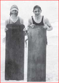 Agatha Christie and a young naval attaché named Ashby stand on Muizenberg Beach, South Africa, following surf bathing, Jan.-March 1922