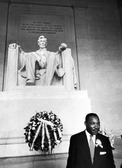 Dr. Martin Luther King, Jr. stands in front of the statue of President Abraham Lincoln at the Lincoln Memorial, Washington, D.C. ca. 1963