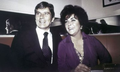 John Warner and Elizabeth Taylor in her favorite purple pantsuit by Halston. 1977