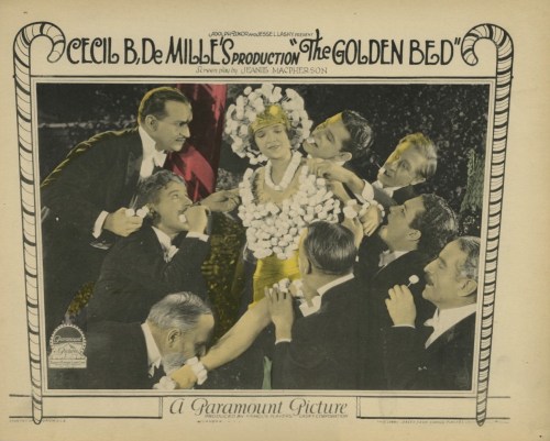 The "Candy Ball" scene from Cecil B. DeMille's 1924 film, "The Golden Bed." Men surround women wearing marshmallow dresses, pull off the sweets, and eat them. 