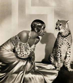 American entertainer Josephine Baker (1906-1936) often performed onstage in Paris nightclubs with pet cheetah Chiquita. Chiquita wore a diamond collar. Sometimes, during a performance, Chiquita would decide to jump off the stage and into the orchestra pit, causing quite a ruckus. Early 1930s. Courtesy of Victoria and Albert Museum. 