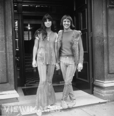 Cher and Sonny wear matching striped bell-bottoms. Sonny often wore a furry open vest, as he is here. ca. 1965