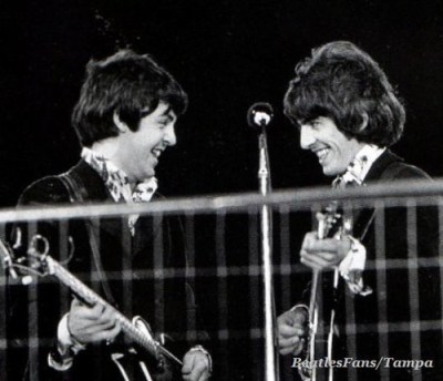 (l. to r.) Paul McCartney and George Harrison perform at Candlestick Park, San Francisco, in August of 1966. This was their final official performance. They were burned out and complained that the fans were so loud they couldn't hear themselves playing the music.